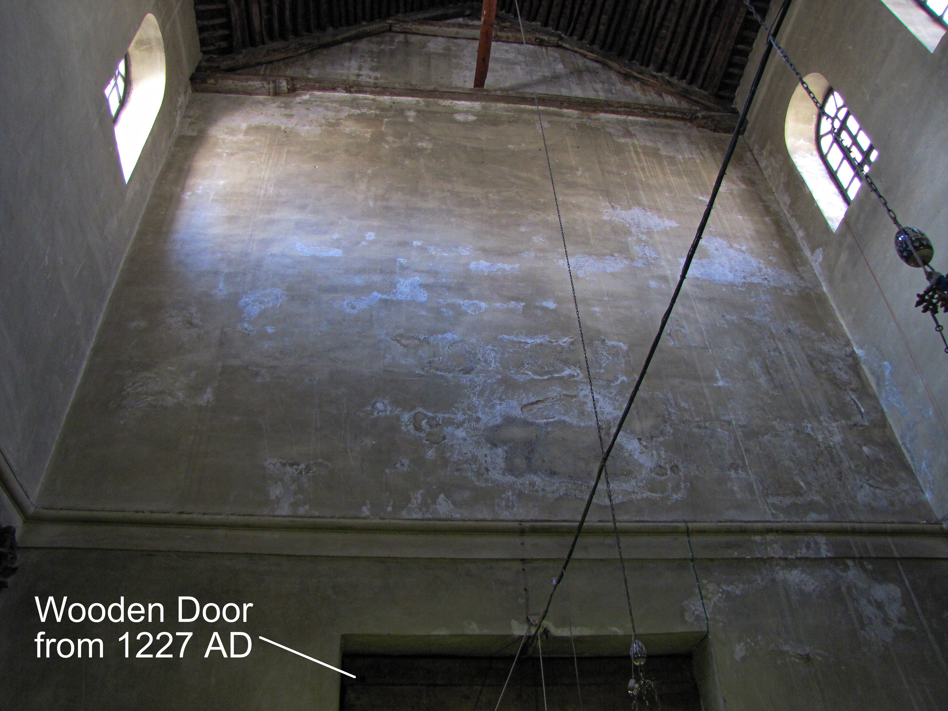 1227 AD wooden door inside the Church of the Nativity and the high west wall of the interior